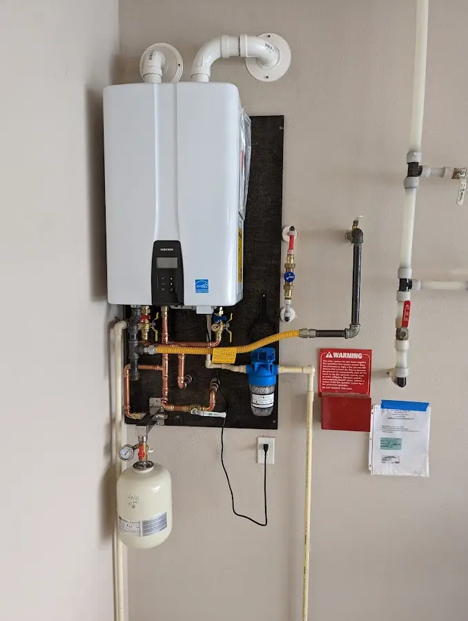 Professional plumber installing copper piping in a Barrington home